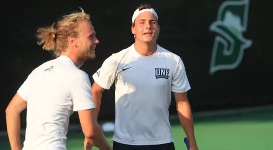 Till Von Winning and Dominik Barton approach each other during a doubles match.