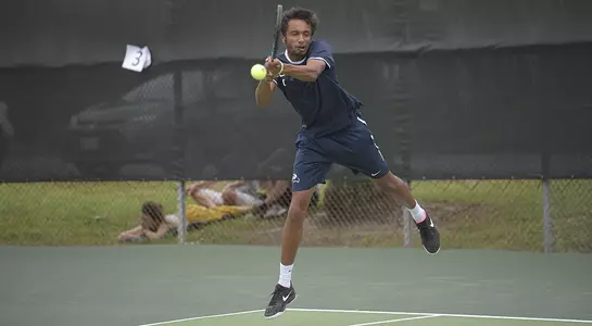 Sahil Deshmukh follows through on a two-hand backhand.