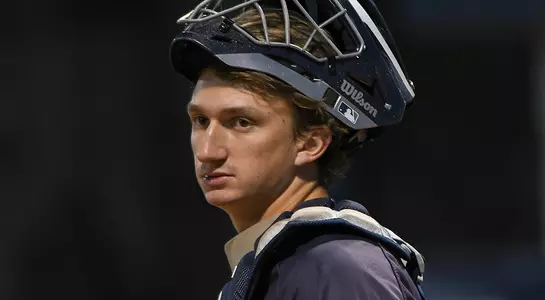 baseball player Tanner Clark with mask off looking to the left