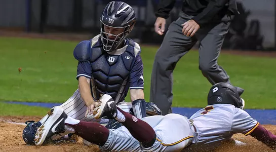 baseball player Tanner Clark tagging somebody sliding into home
