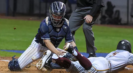 baseball player Tanner Clark tagging somebody sliding into home