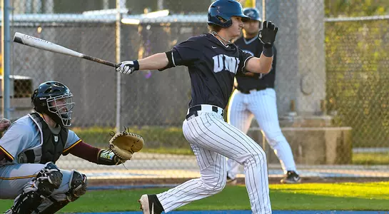 baseball player Tanner Clark finishing his swing batting