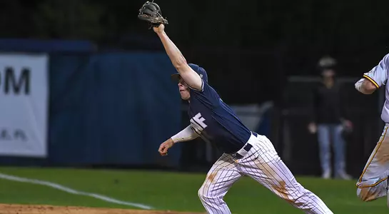 baseball player Jay Prather stretching to catch a ball at first