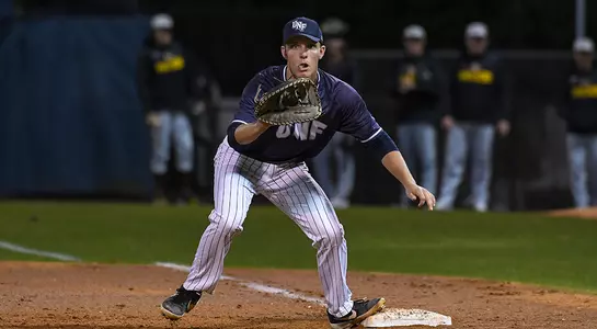 baseball player Alex Reynolds receiving ball at first base