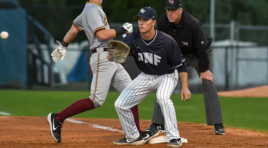 baseball player Alex Reynolds receiving baseball at first base