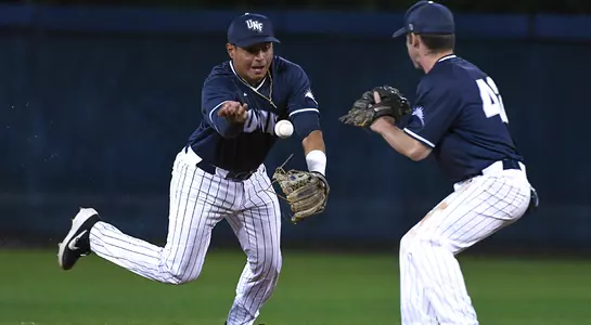 Baseball player Abraham Sequera flipping ball to Jay Prather