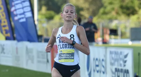 Audrey Carpenter runs down home stretch of the 10,000 meter race