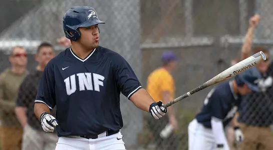 David Maberry holding a baseball bat looking on at the pitcher.
