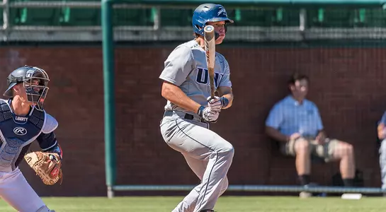 Chris Berry looks at the ball after making contact with it.
