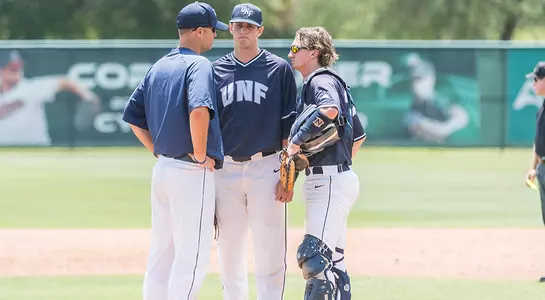 Coach Tommy Boss, Nick Marchese and Tanner Clark discuss things on the mound.
