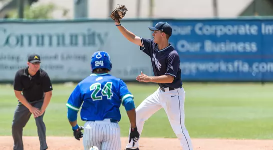 First baseman Alex Reynolds stretches out to make the play at first.