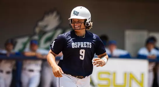 Navia Penrod smiles as she heads to first base.