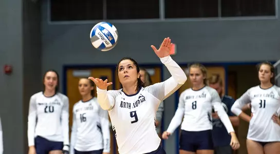 Miriam winds up for a serve