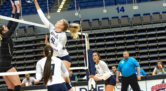 Taryn (42) hits the ball over the net