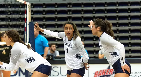 Gabby (middle) helping her teammates