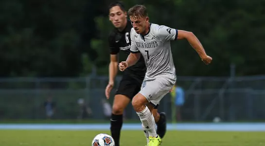 Jake Hawker moves past a defender in the UNF Soccer game.