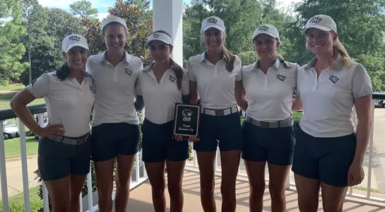 Women's golf team poses with runner-up plaque following play at the USA Intercollegiate