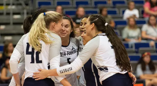Taryn (42) huddles with the team