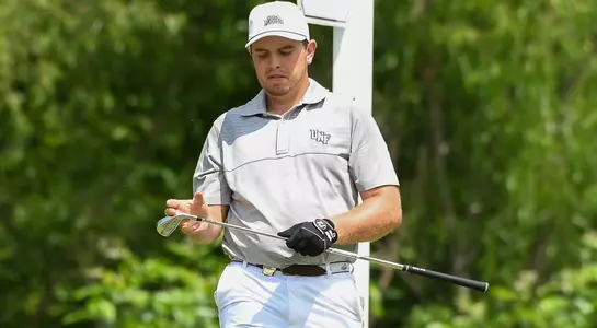 Michael Mattiace looks at his club head after hitting a shot