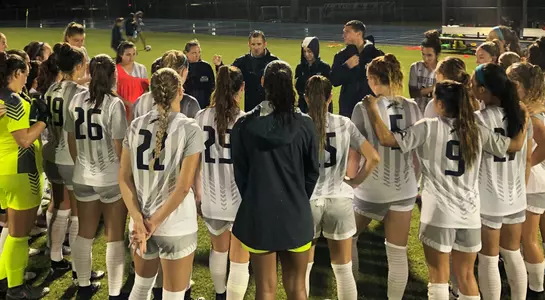 North Florida women's soccer team huddles up on field after a game