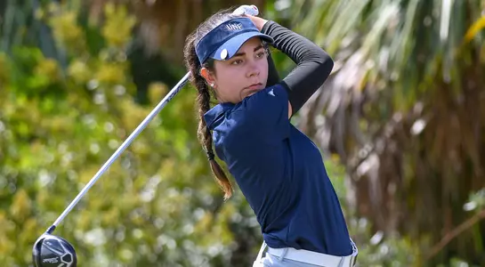 Liss Davalos completes her swing with her driver and watches the ball