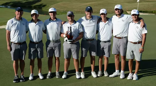 Men's golf team poses with trophy after winning the 2019 Graeme McDowell Invitational