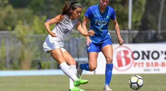 Karina Bermudez kicks the ball past a defender