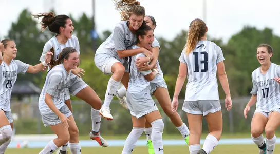 North Florida women's soccer team huddles in celebration of game winning goal