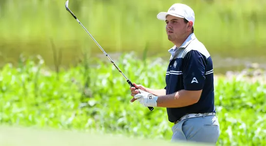 Michael Mattiace watches his shot fly out of the sand trap