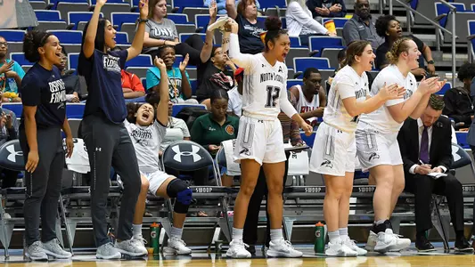 North Florida women's basketball bench celebrates at the game.