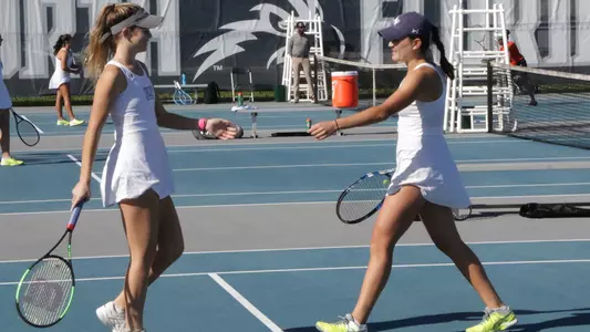 Cons Gorches and Kendall Nash high five on the courts