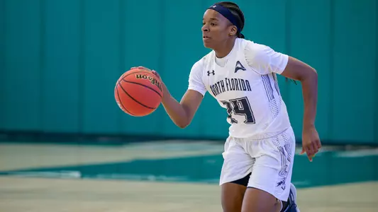 Janesha Green dribbles up the court against JU.