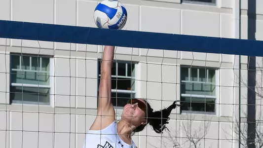 Dana Roskic attacks the ball at the net.