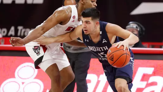 Jose Placer dribbles past a North Carolina State defender