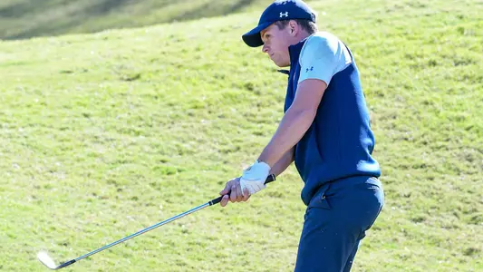 Michael Saccente follows through on his golf swing from the fairway