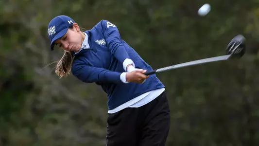 Liss Davalos swings her driver on the tee box
