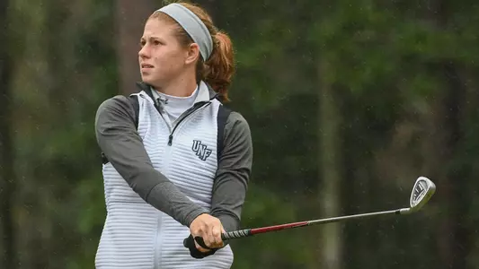 Sydney Shrader watches her shot after making a golf swing