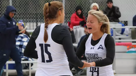 Sydni Small and Leah Maloney high five