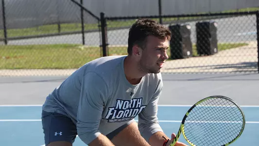 Matt Carroll men's tennis waits for a serve.