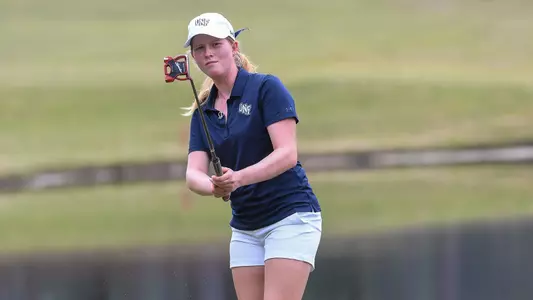 Teresa Conroy watches her putt roll on the green