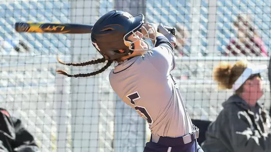 Shannon Glover swings the softball bat.