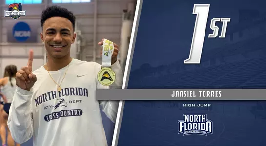 jaasiel torres holding up gold medal at asun indoor championship