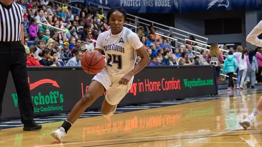 Janesha Green goes to drive up the basketball court.