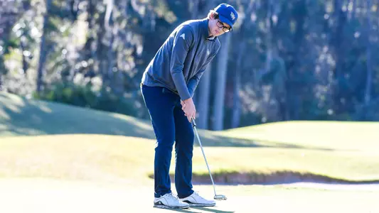 Cody Carroll putts the ball on the green