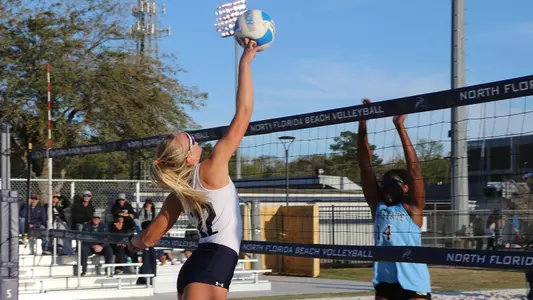 Blaire Register jumps up to hit the ball.