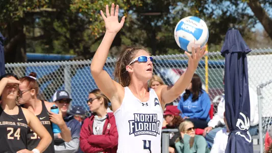 Carolyn Cain serves the ball.