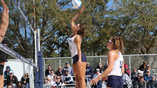 Marisa Rogers jump up to make contact with the ball.