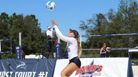 Callie Workman jumps up to serve the ball.