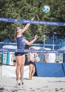 Carolyn Cain hits the ball over the net.