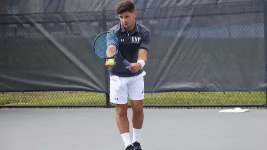Joe Ellis gets ready to make a serve.